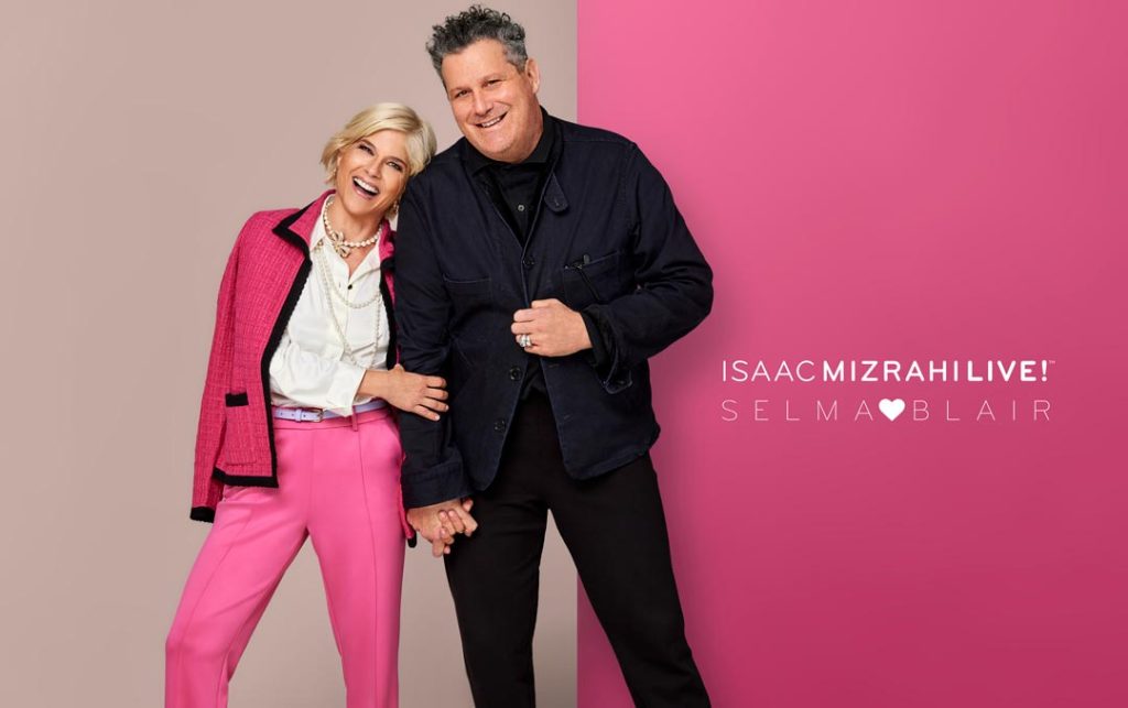 Selma Blair and Isaac Mizrahi holding hands in photo shoot image