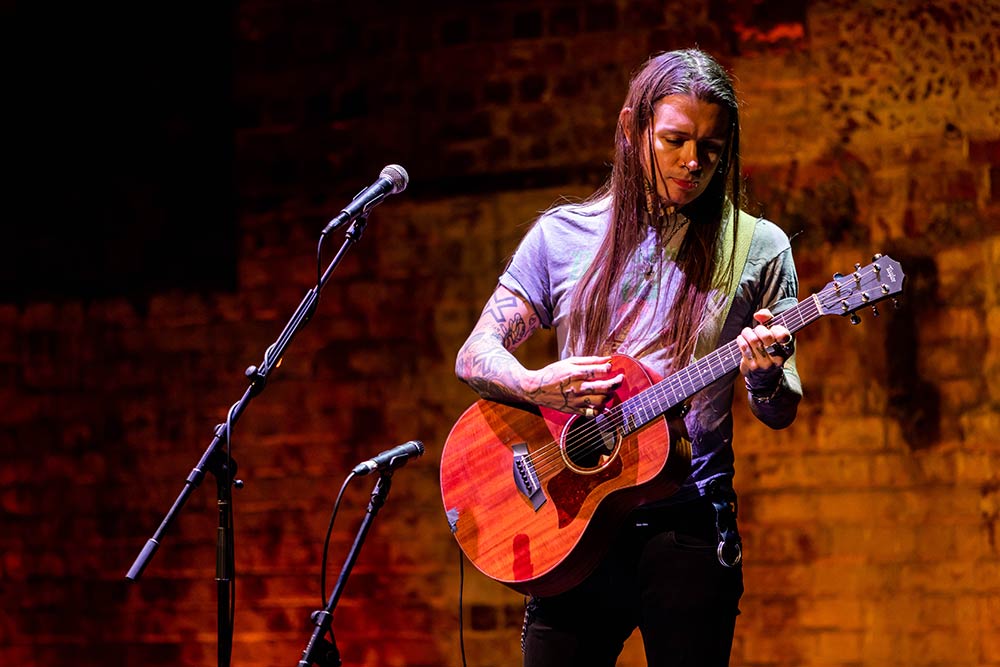 Nat on stage playing guitar