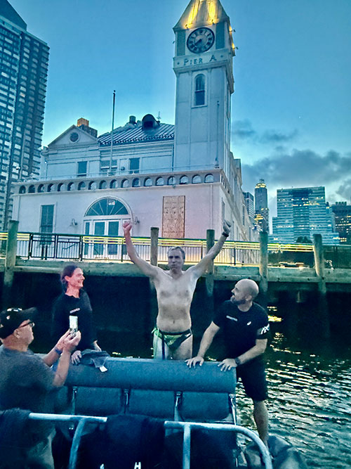 gerrard celebrating with arms raised on boat with team